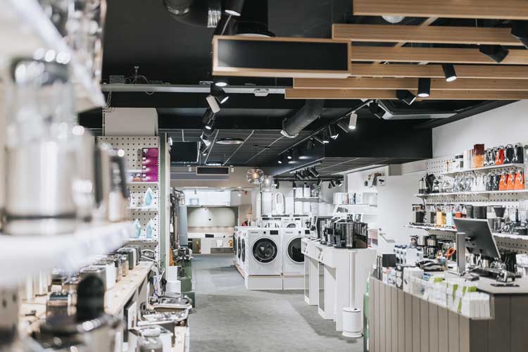 Interior of electronics store with various appliances arranged for sale